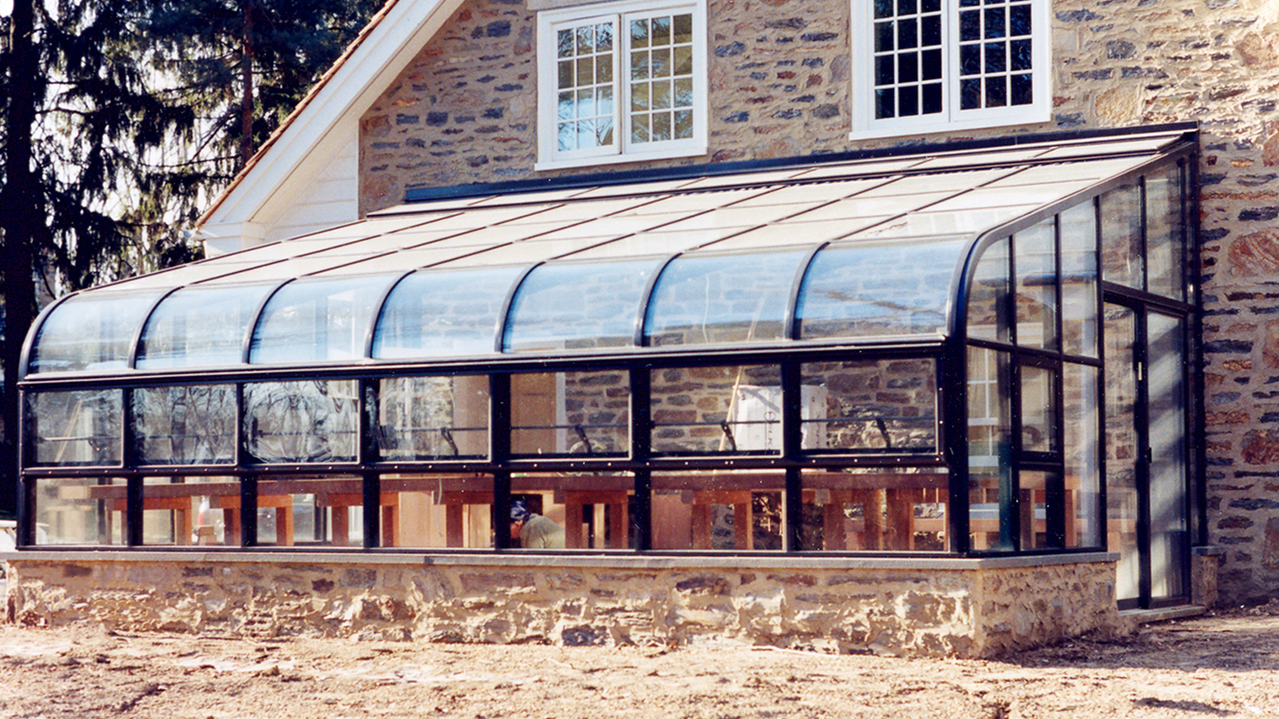 Curved eave lean to on this residential home.