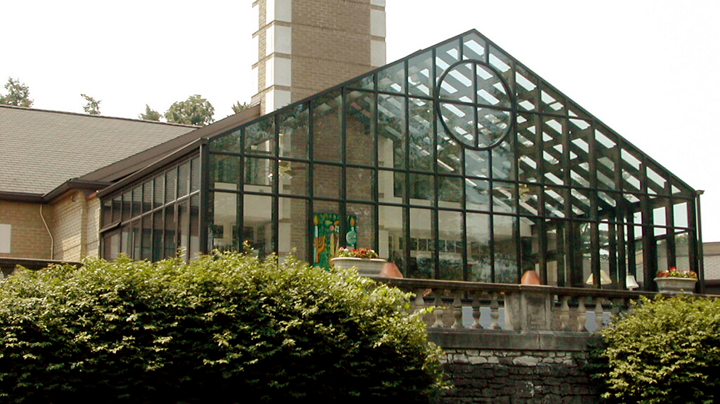Straight eave double pitch conservatory with a circular gable pediment