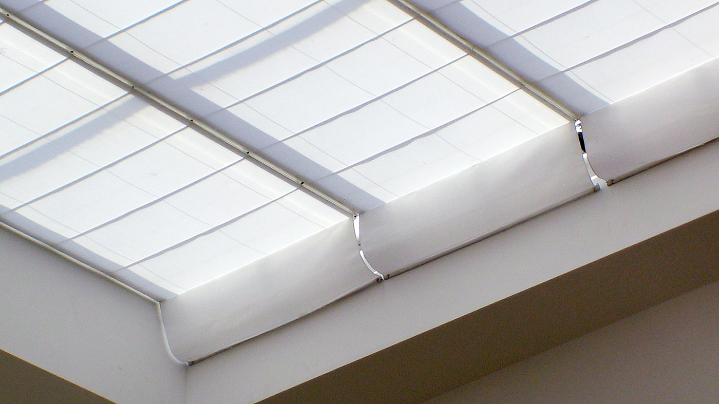 Single slope skylight with wide span shades