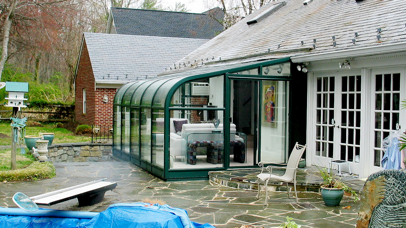 Curved eave lean-to sunroom with a two-panel (XO configuration) sliding glass door unit