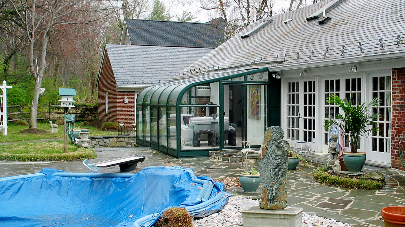 Curved eave lean-to sunroom with a two-panel (XO configuration) sliding glass door unit