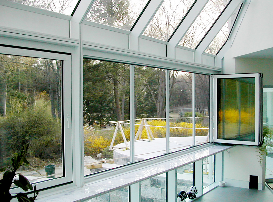 Complete glazing package, including single slope skylights, French doors, entryway roof access skylight with a terrace door, sliding glass doors, bifold windows, casement windows and a pool house.