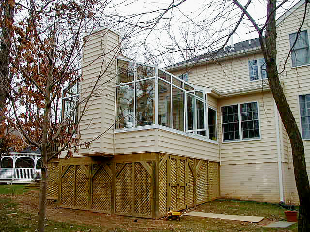 A pair of straight eave lean-to sunrooms with integrated windows and a door