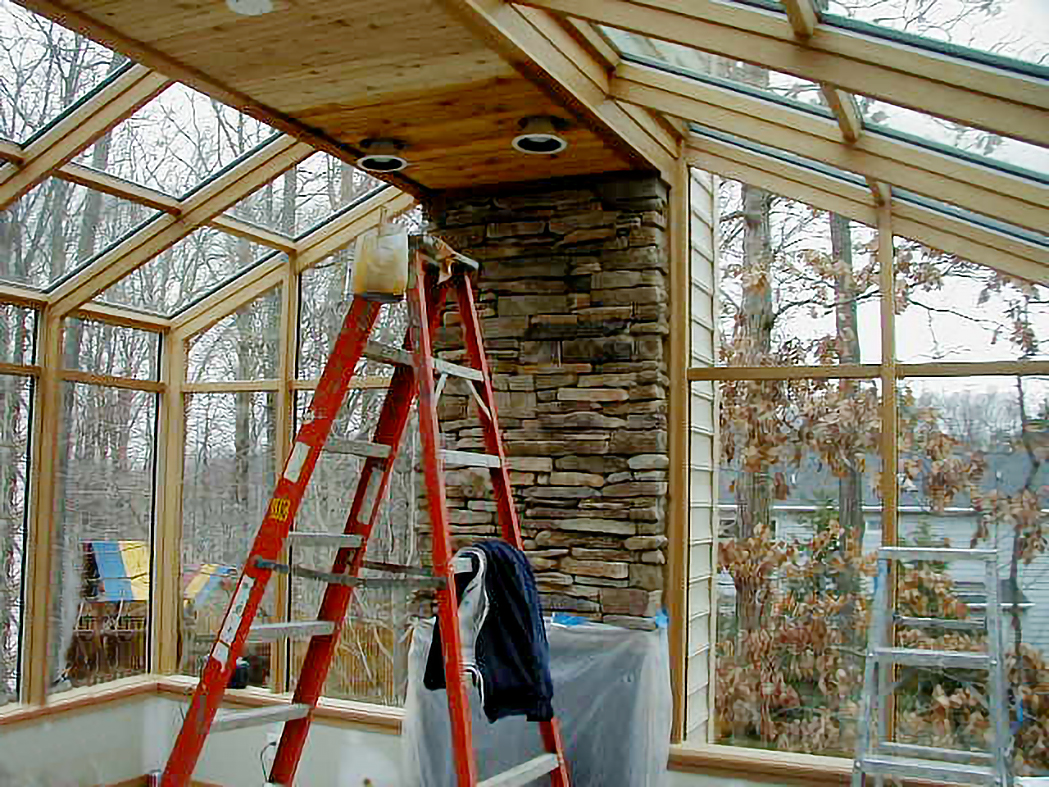A pair of straight eave lean-to sunrooms with integrated windows and a door