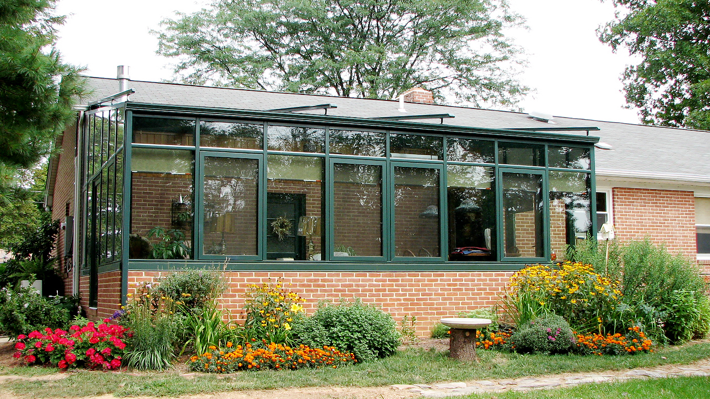 Straight eave lean to sunroom with two gable ends and exterior mounted sun shade system