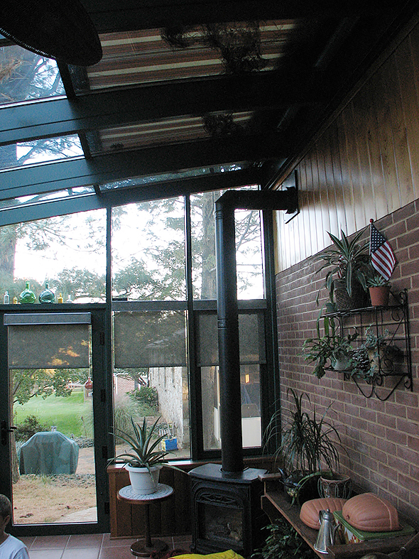 Straight eave lean to sunroom with two gable ends and exterior mounted sun shade system