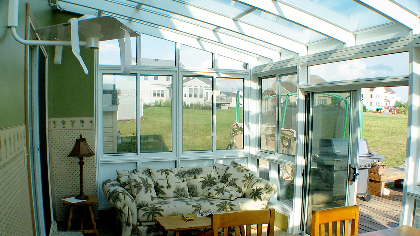 Straight eave lean to sunroom with sliding doors and windows
