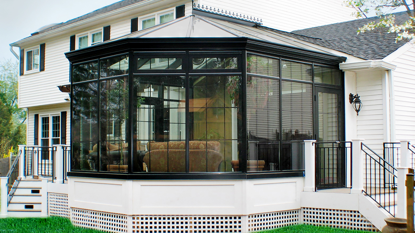 Straight eave, double pitch conservatory with bull nose including transoms, grid work, gutter, finial, and ridge cresting.