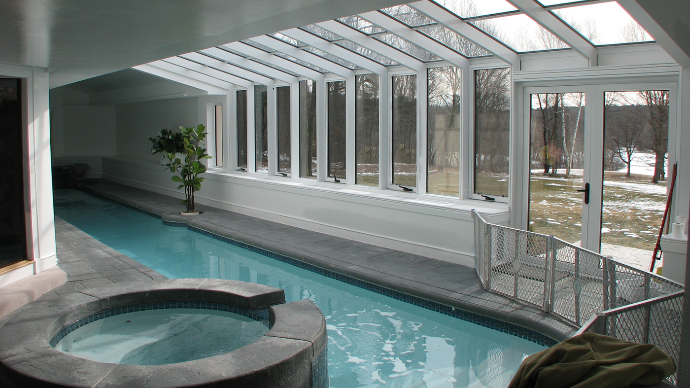 Straight eave, lean-to pool enclosure with awning windows and French doors