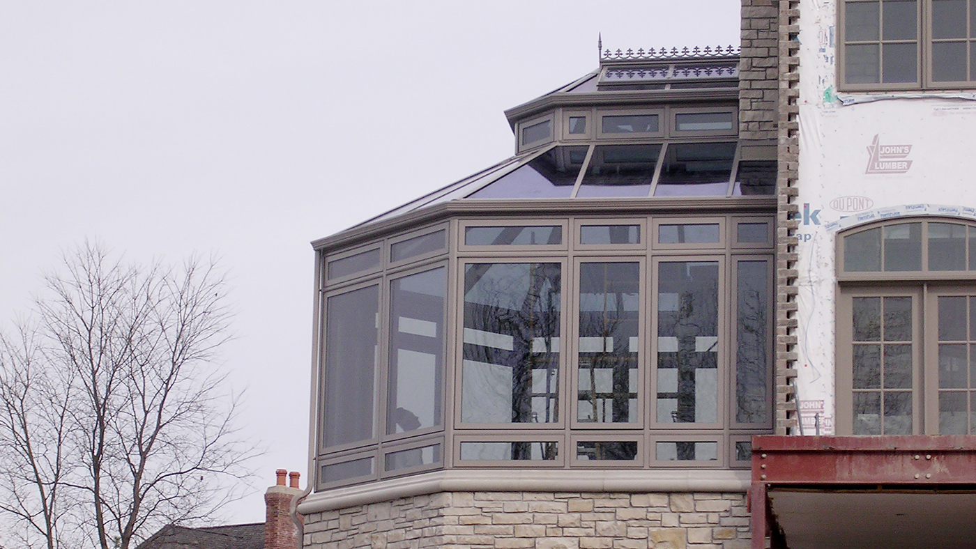 Straight eave, double pitch conservatory with Natural Clay aluminum exterior/Mahogany interior, lantern, ridge cresting, finial, and transoms.