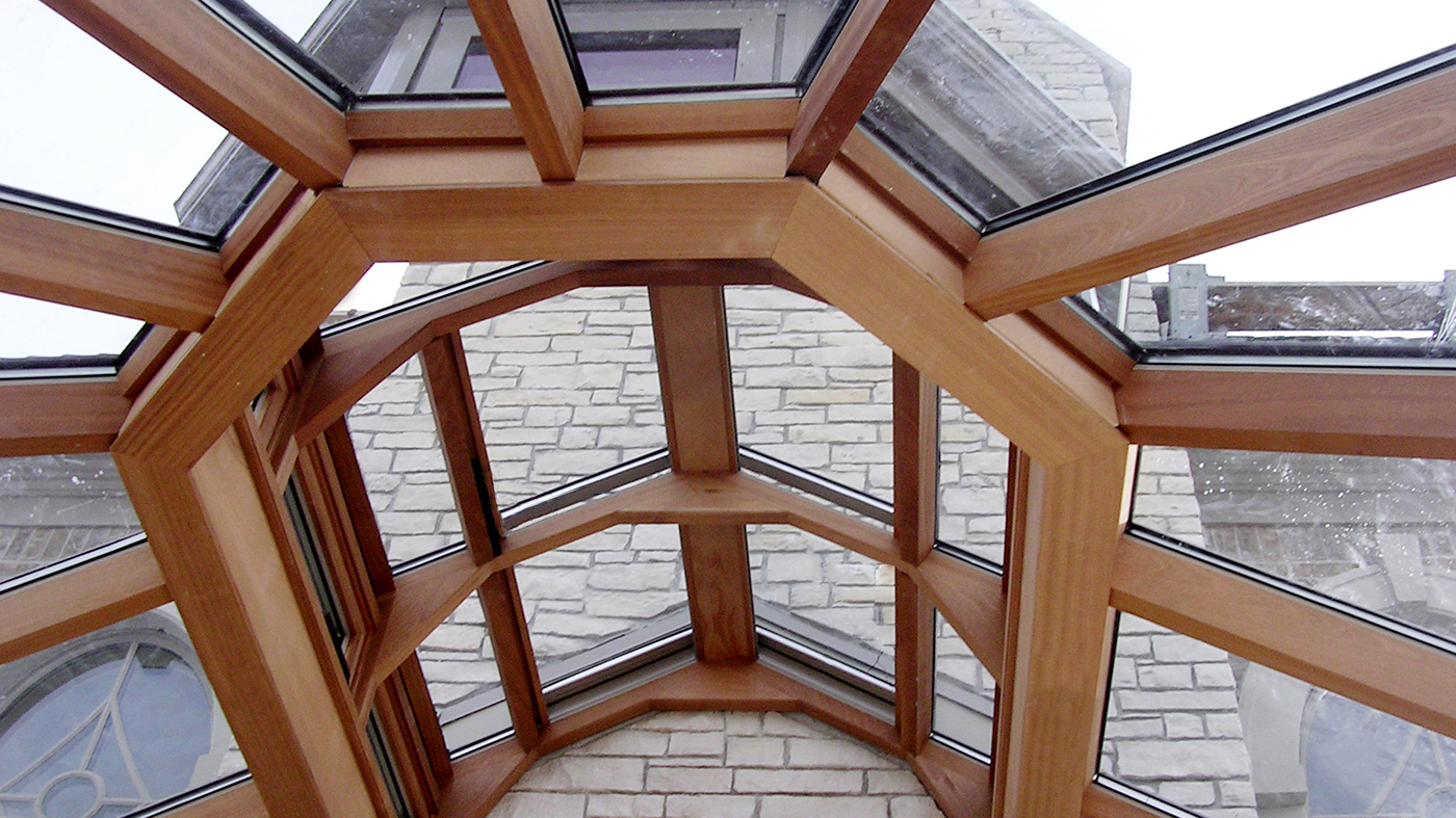 Straight eave, double pitch conservatory with Natural Clay aluminum exterior/Mahogany interior, lantern, ridge cresting, finial, and transoms.