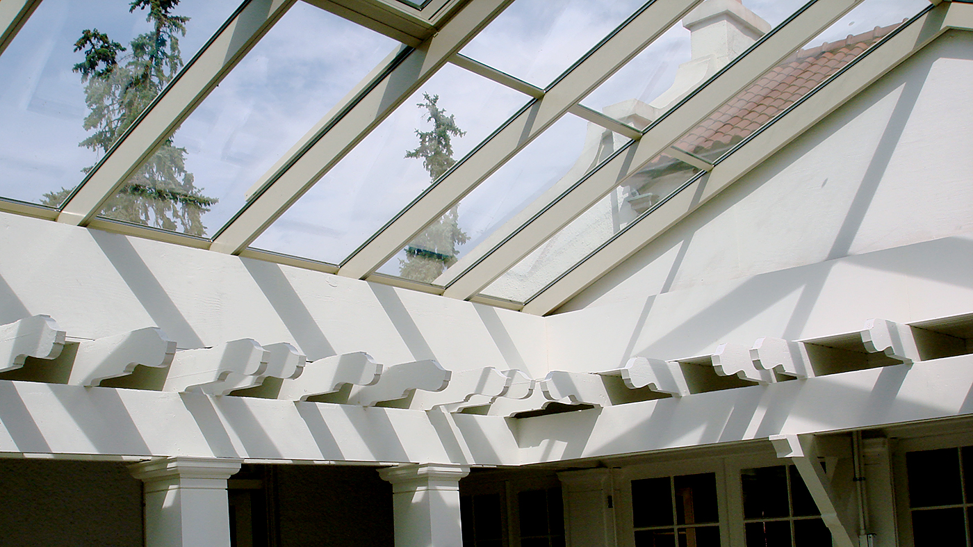 Straight eave double pitch sunroom and a lantern with two hip ends, ridge cresting, finials and ridge vents.