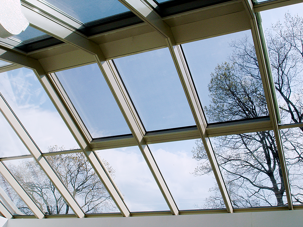 Straight eave double pitch sunroom and a lantern with two hip ends, ridge cresting, finials and ridge vents.