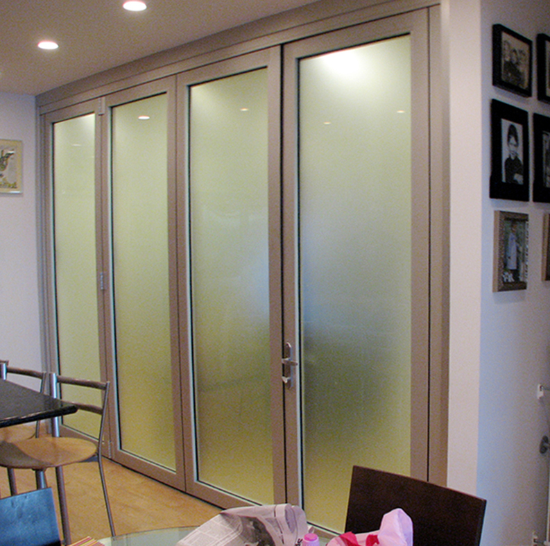 Folding wall system, single door hinge jamb configuration with one operable panel. The wall is interior, used with an office, and features specialty acid etch