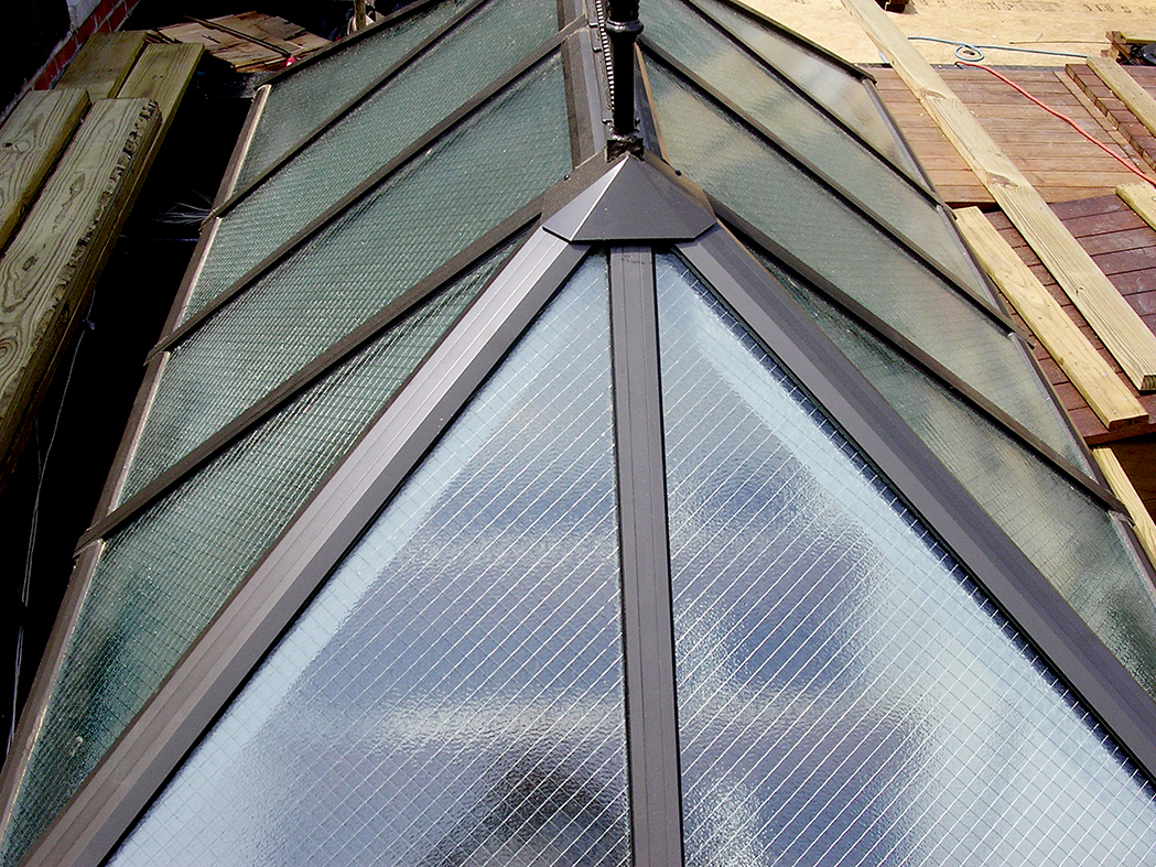Three straight eave double pitch hip end skylights with wired glass