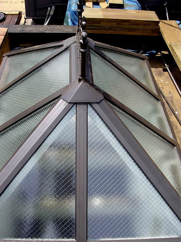 Three straight eave double pitch hip end skylights with wired glass