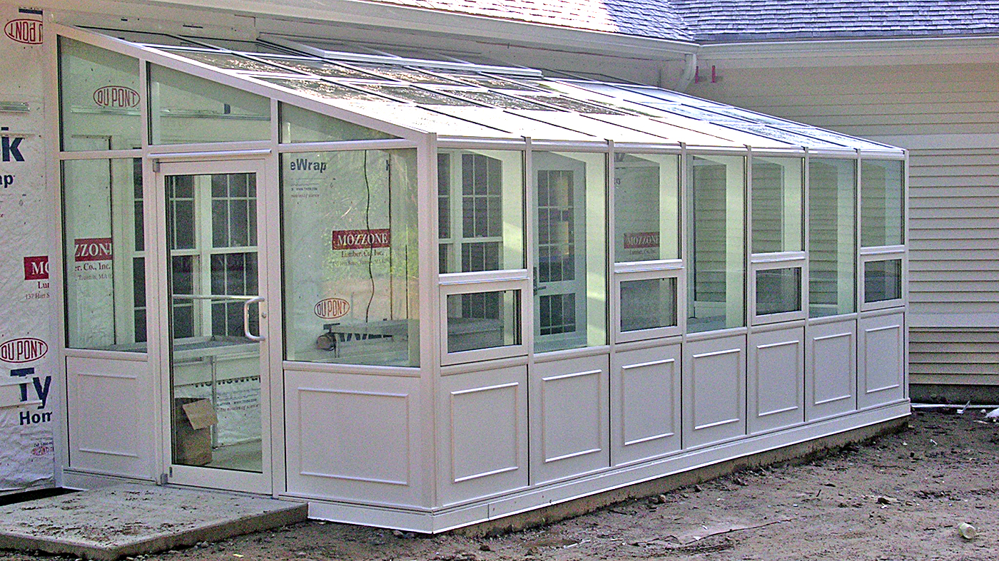 Straight eave lean-to greenhouse with two gable ends.