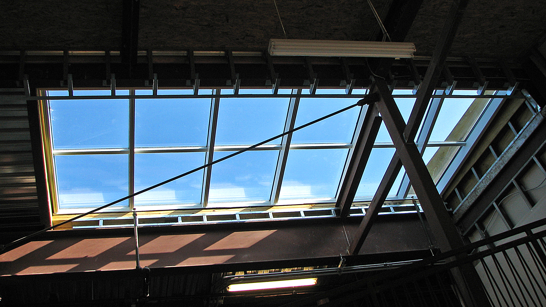 Irregular straight eave lean-to skylight.