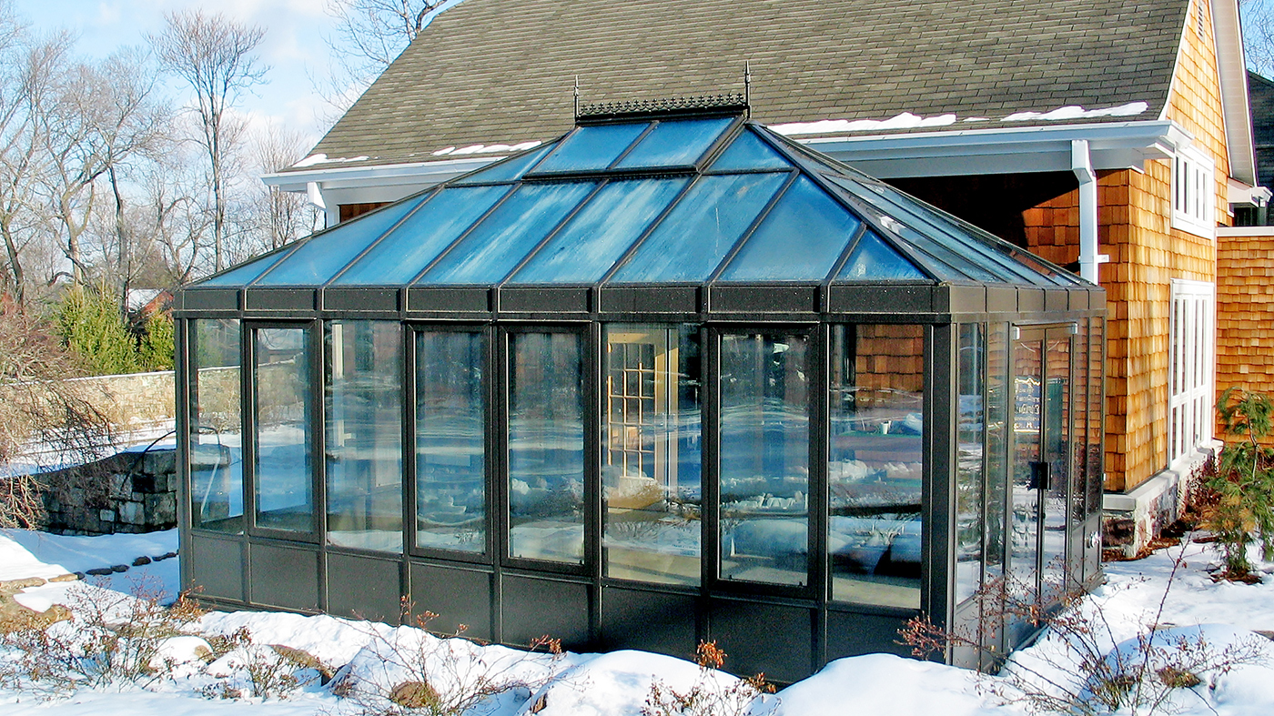 Straight Eave Double pitch conservatory with two hip ends and walkway to main building