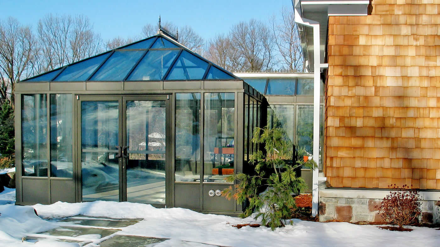 Straight Eave Double pitch conservatory with two hip ends and walkway to main building
