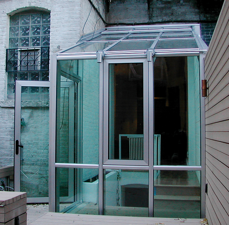 Straight eave lean-to sunroom used to a cover a staircase, including a casement, terrace door and ridge vent