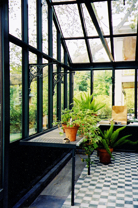 Straight eave double pitch, conservatory greenhouse with decorative base panels, ridge cresting, and operable ridge vents.