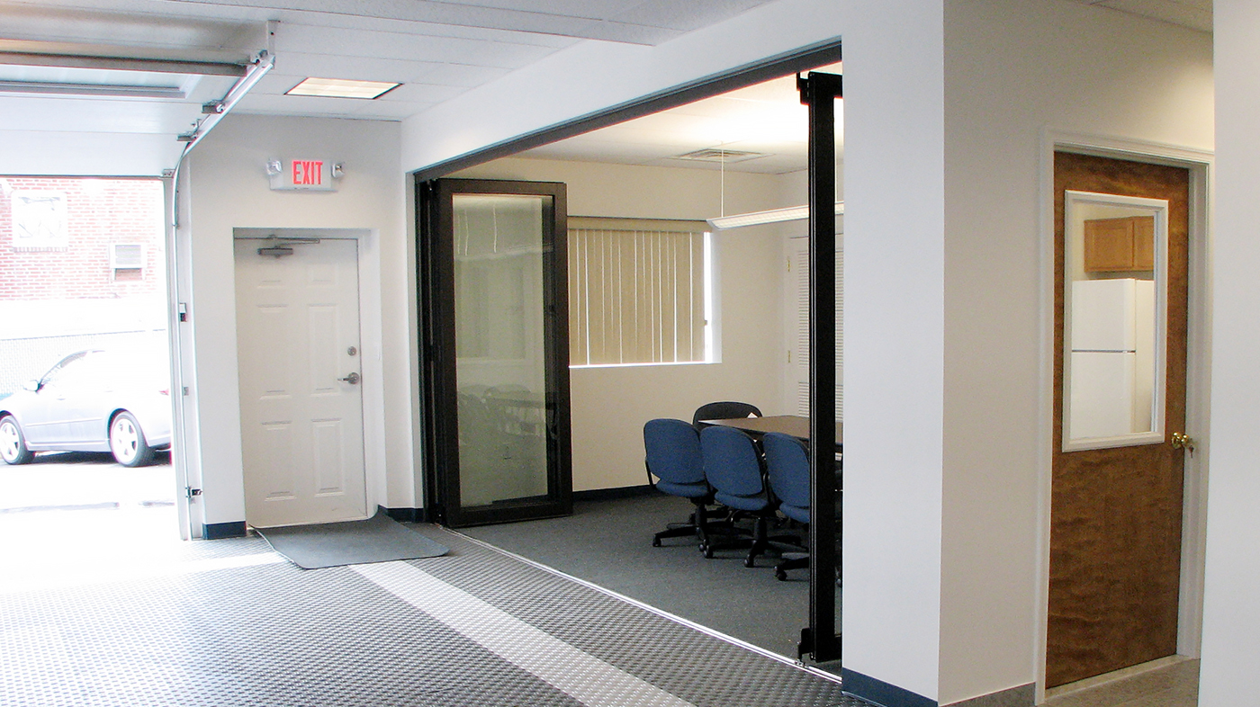 Restoration folding glass wall system used in an office application