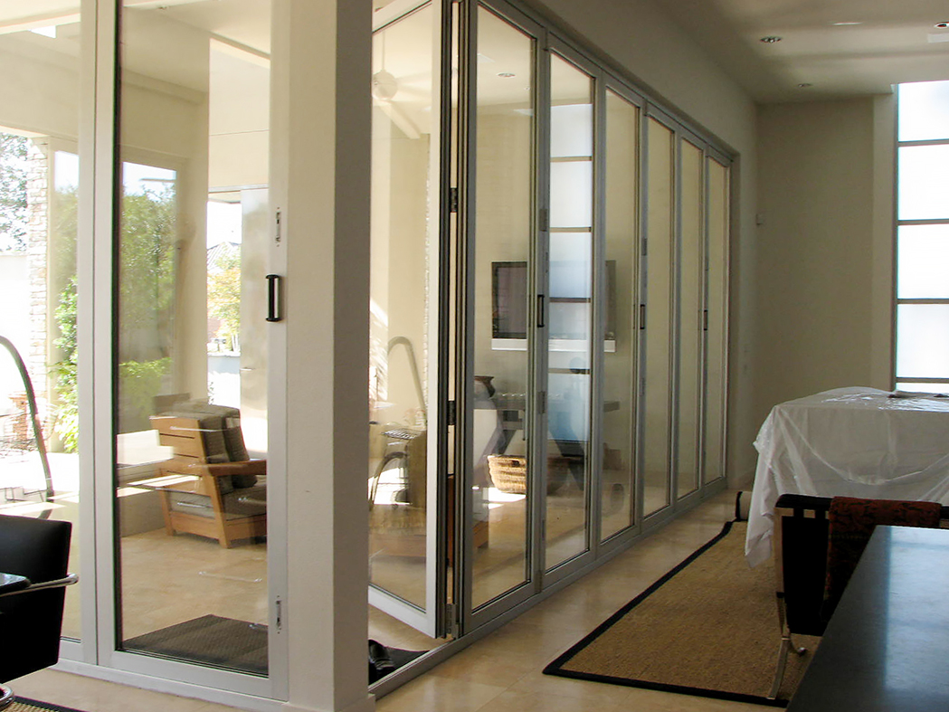Three folding glass wall systems: two all wall systems, one single door system.