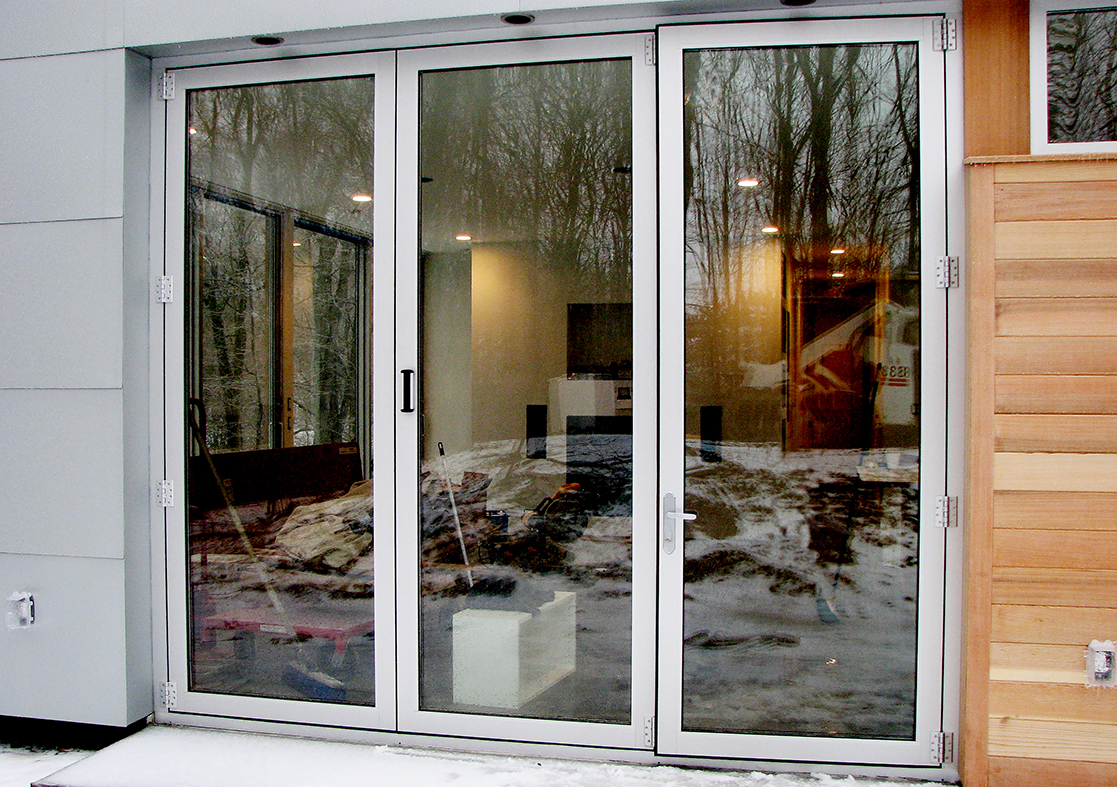 Complete glazing solution: Seven fixed windows, one casement window, three two-panel (XO configuration) dual-track sliding glass window units, one three-panel bifold door, and one French door.