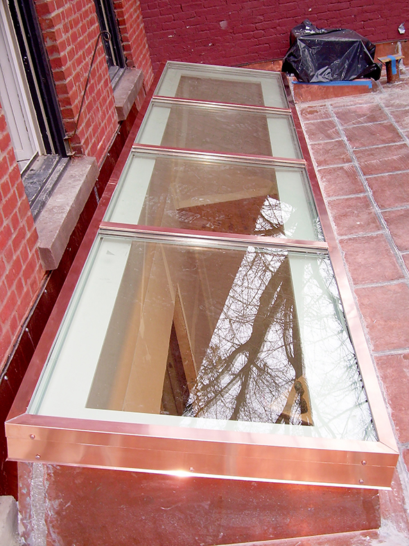 Single slope, curb mount skylight with exterior copper cladding. The skylight was shipped pre-assembled to the job site.