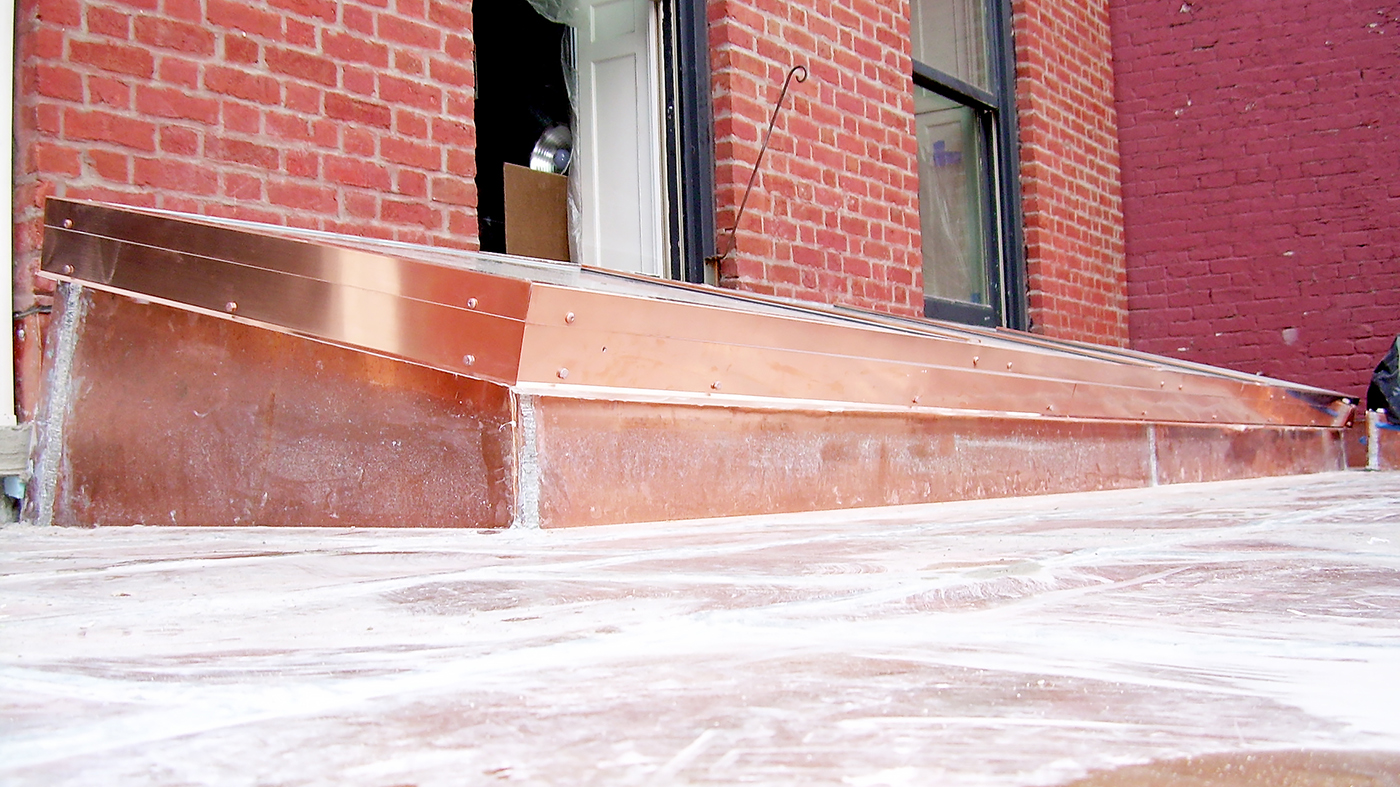 Single slope, curb mount skylight with exterior copper cladding. The skylight was shipped pre-assembled to the job site.