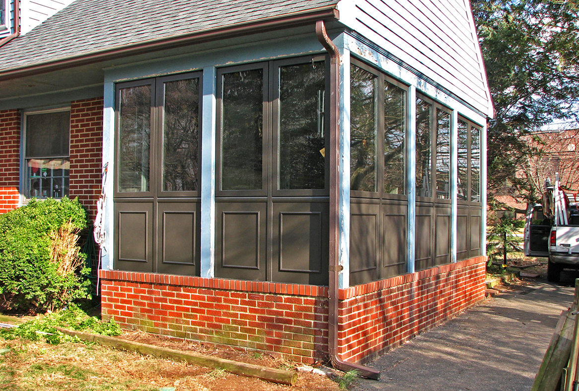 Porch enclosure with outswing door and casement windows.