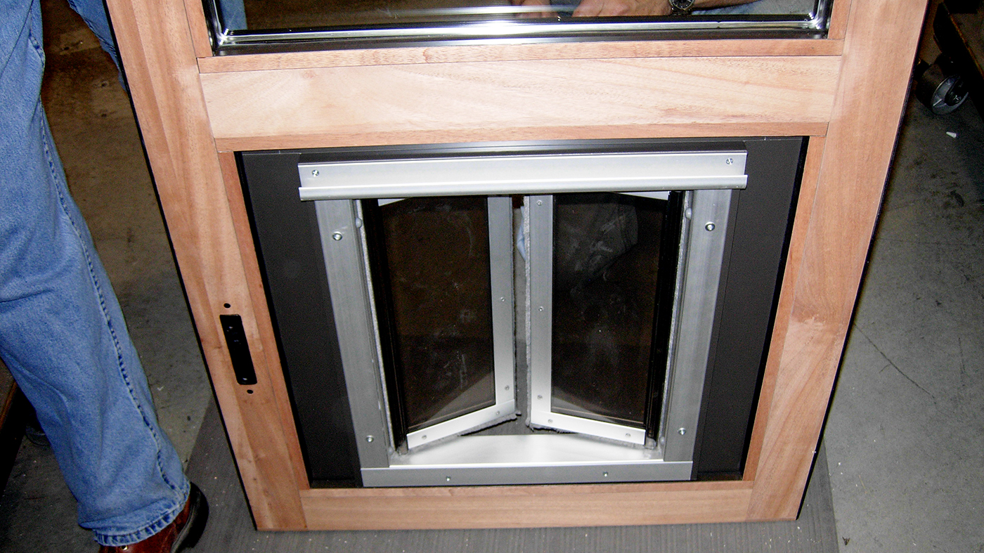 Three sets of bifold doors with one panel incorporating a Plexidor dog door