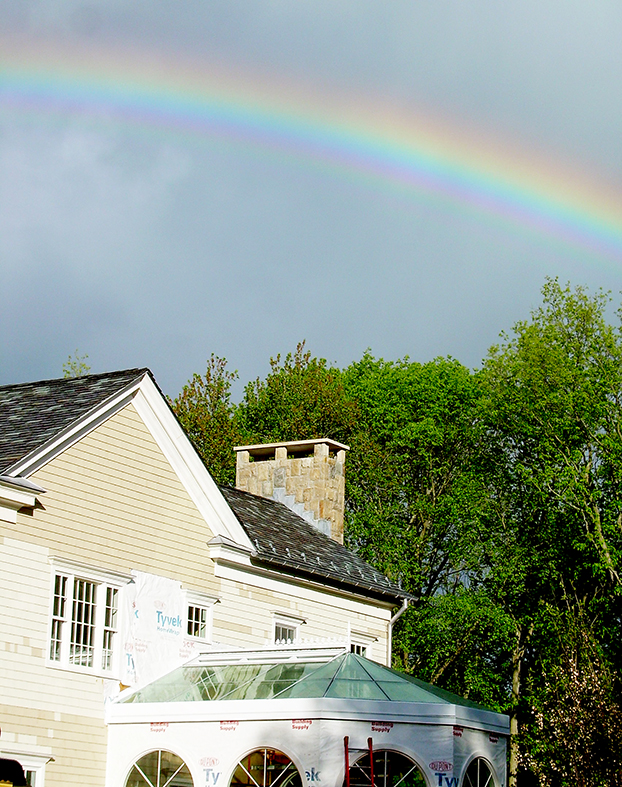 Straight eave double pitch bullnose end skylight with a rainbow in the photo