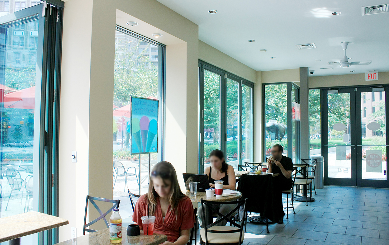 Two folding wall systems used at a cafe. Each unit has an all wall configuration, four panels that fold out and a recessed sill