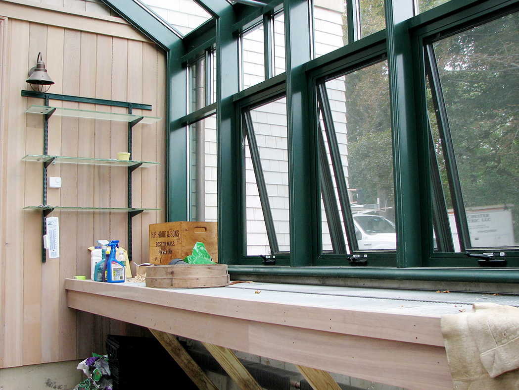 Straight Eave double pitch hobby greenhouse with one gable end, copper gutter, transoms, awning windows, and ridge vents.
