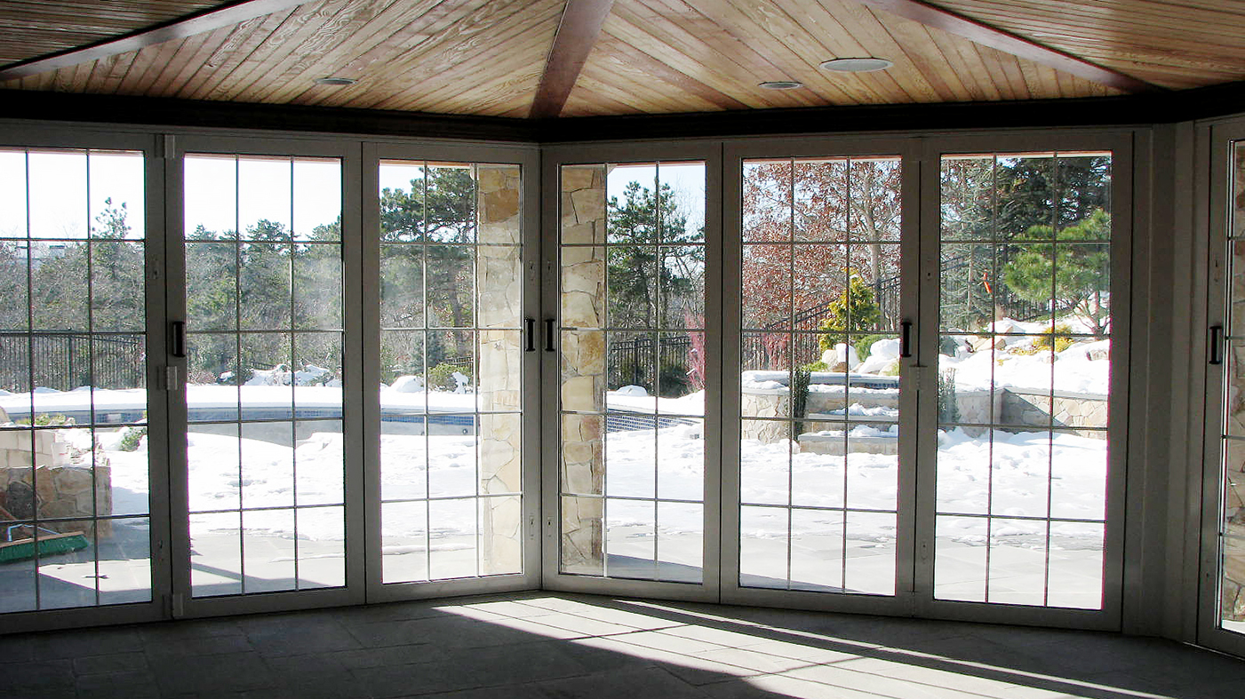 five all wall folding door systems with panels that fold to the interior which feature interior muntin gridwork, and a recessed sill with flush stop