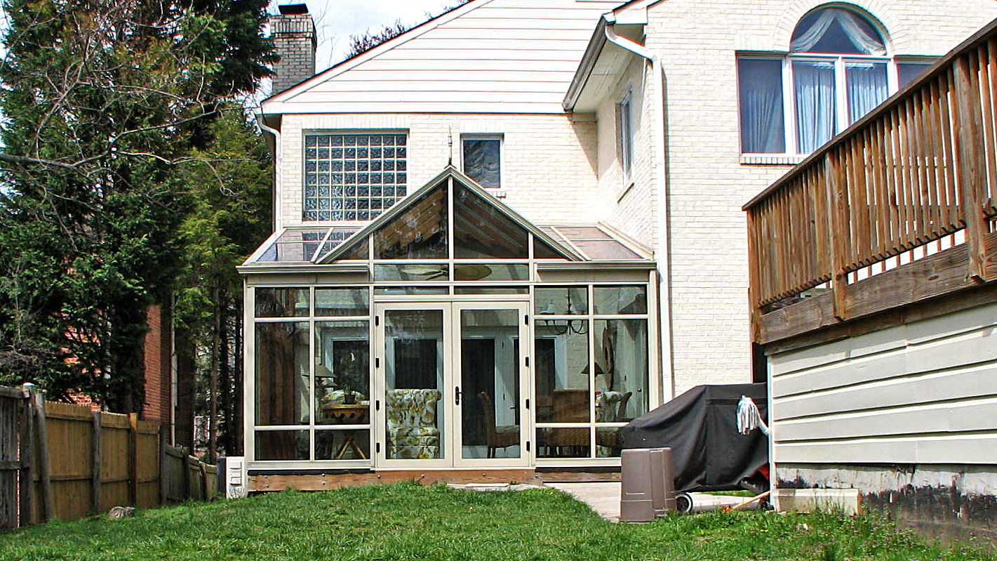 Straight eave lean-to conservatory with mahogany interior veneer.