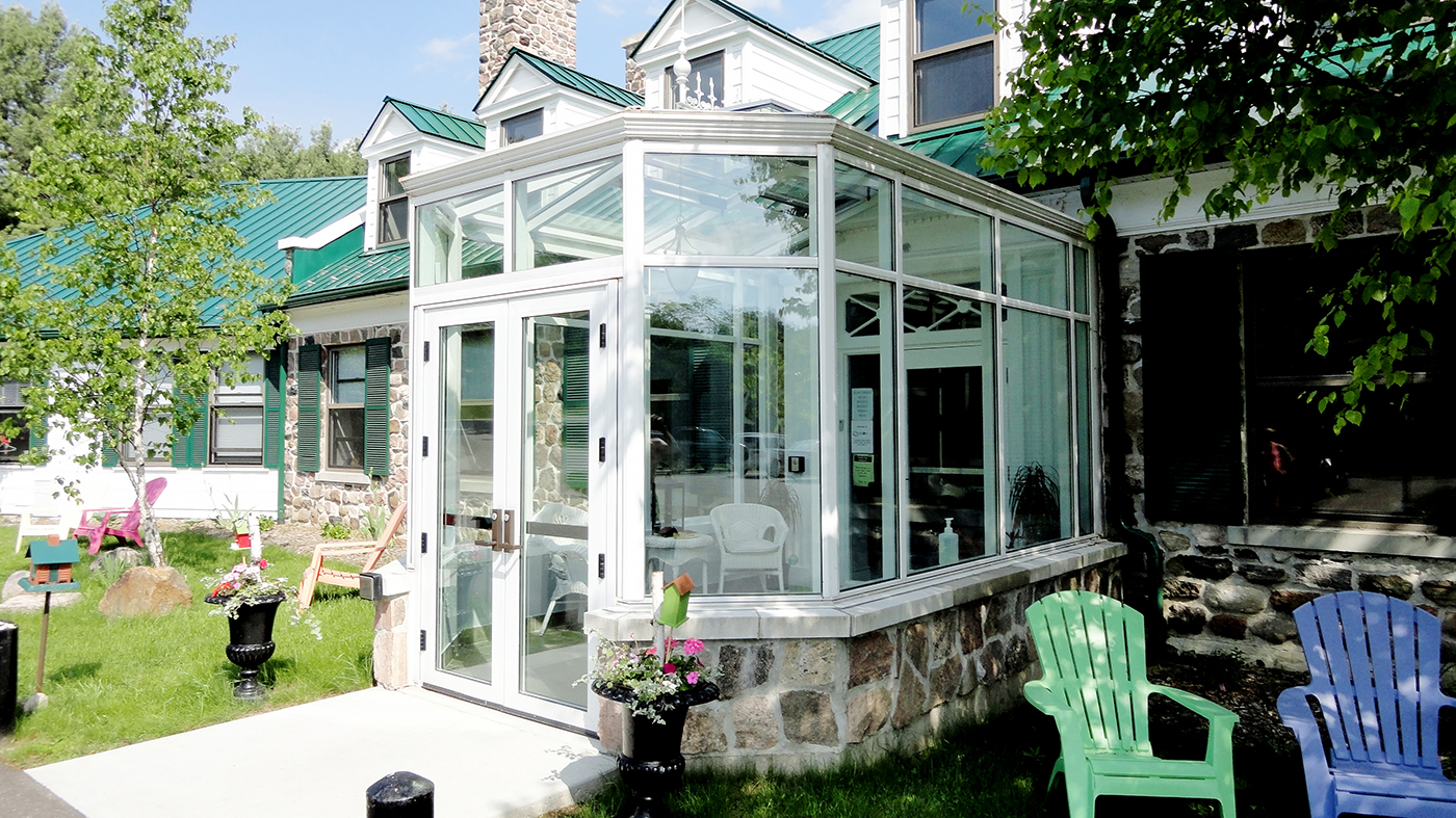 Irregular straight, eave double pitch conservatory with one conservatory nose, finial, and ridge cresting