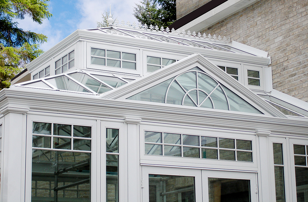 Straight eave double pitch  hip end conservatory with a roof lantern and two dormers.