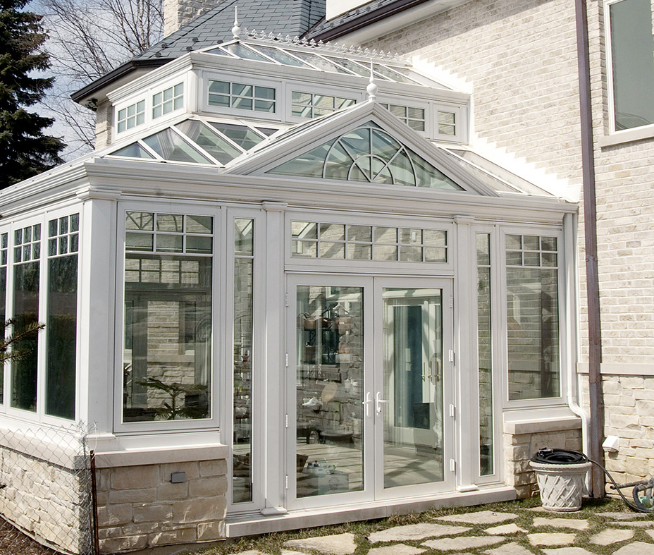 Straight eave double pitch  hip end conservatory with a roof lantern and two dormers.