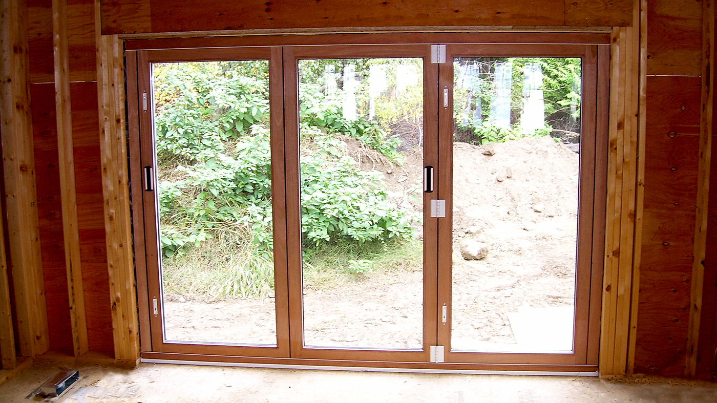 Two sets of bifold doors with wood veneer interiors