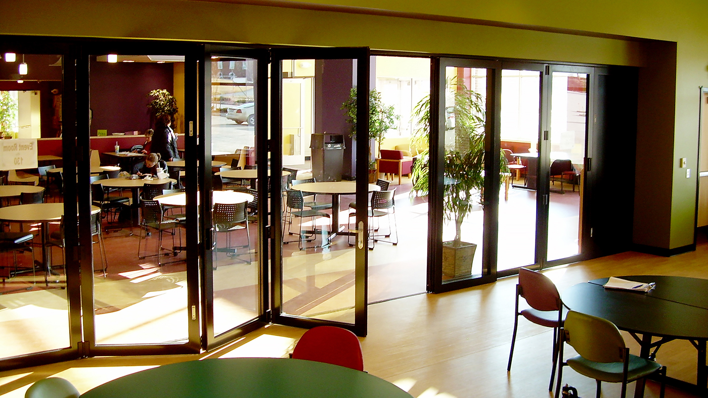 Folding glass wall system with ten panels, a double door midwall. Featured in a black frame finish.  