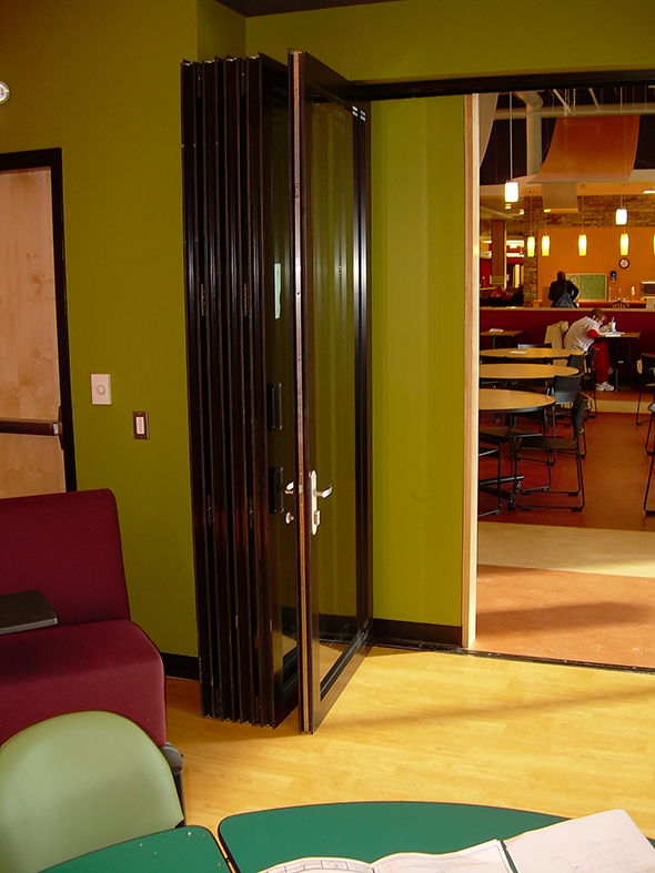 Folding glass wall system with ten panels, a double door midwall. Featured in a black frame finish.  