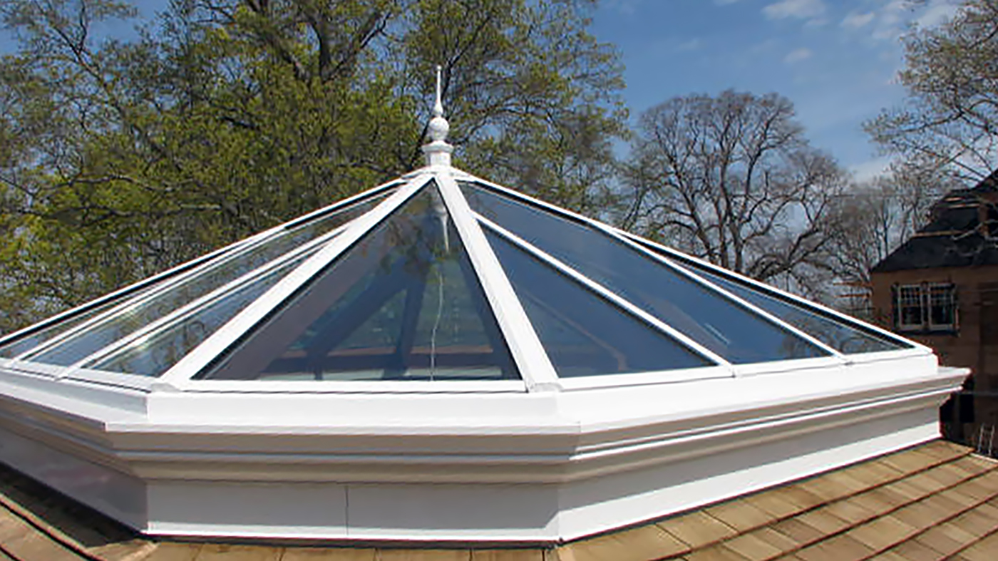 Irregular pyramid skylight with four hip ends. Interior ogee on face of all rafters, bullnose sill extension, and exterior finial.