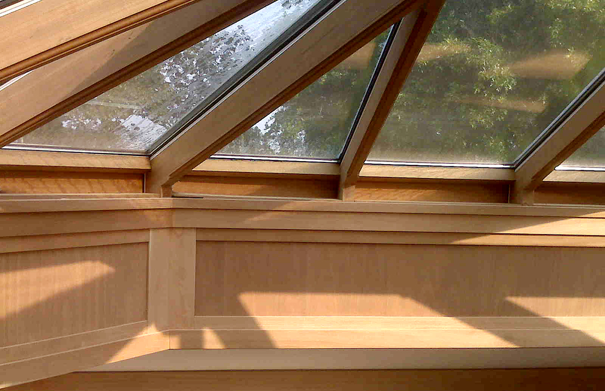 Irregular pyramid skylight with four hip ends. Interior ogee on face of all rafters, bullnose sill extension, and exterior finial.