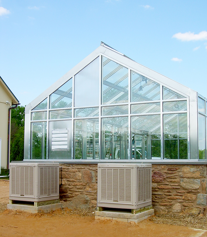 Straight eave double pitch I-Beam greenhouse with two gable ends; includes French door, operable ridge vents, evaporation coolers, shutter fan, and greenhouse benches.