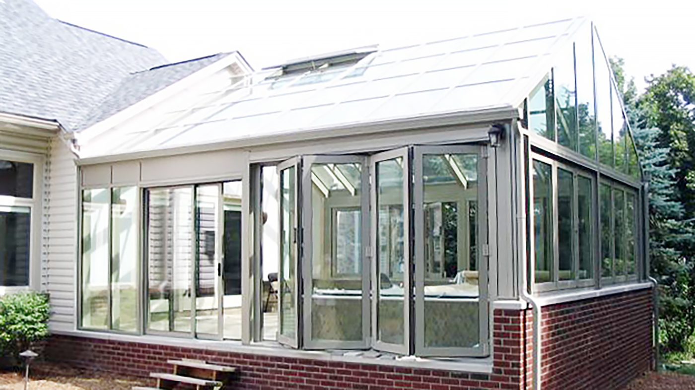 Straight eave double pitch pool enclosure with ridge vents, folding windows, a folding wall and a sliding door system.