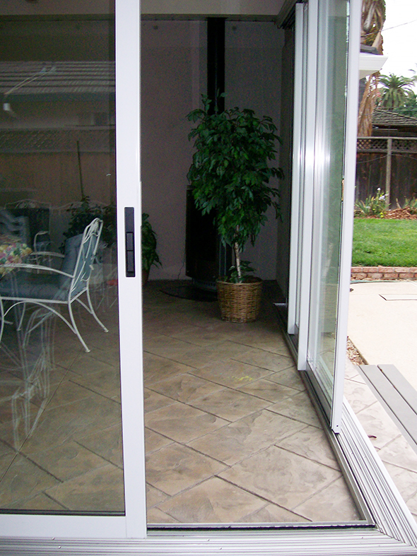 Two multi-track sliding door systems meeting at a no post corner.