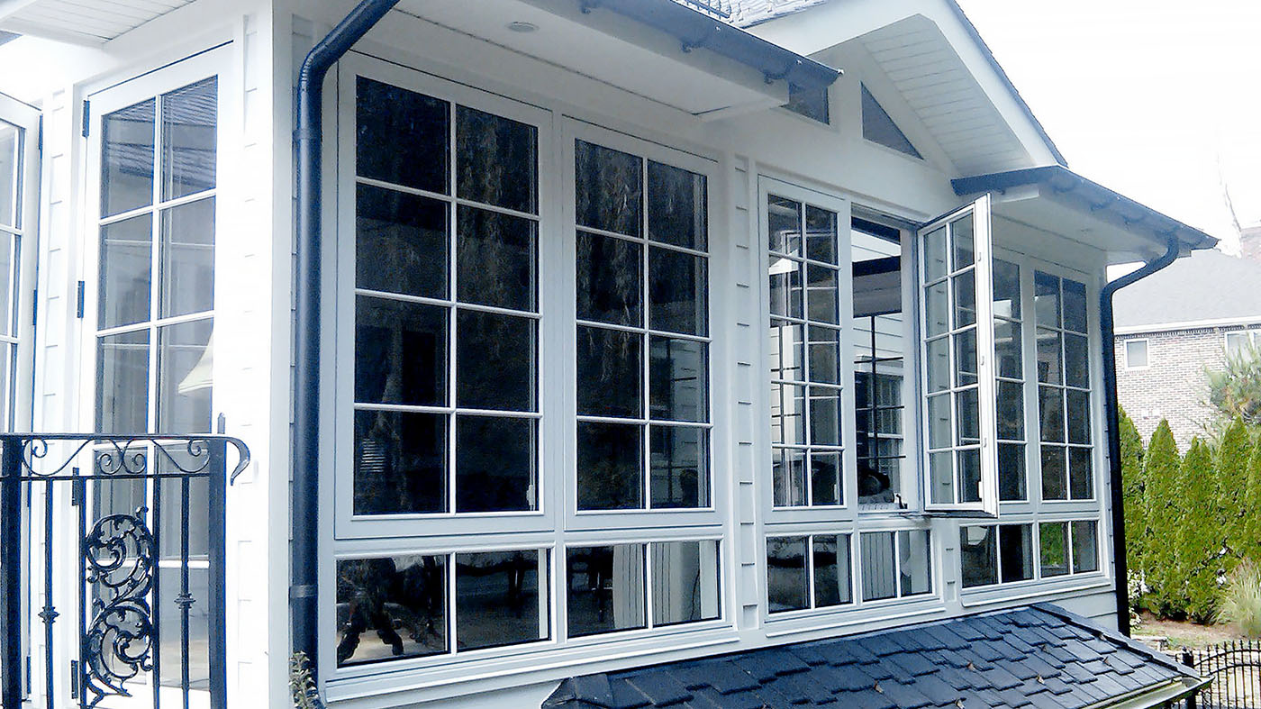 Multiple European window/wall systems in one home. French doors, curtain walls and casement windows used in traditional construction. Units showcase SDL grids.